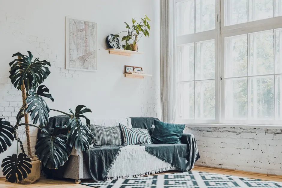 Bright, white-walled living room with pale wood floors and airy natural light, illustrating a Scandinavian-style interior